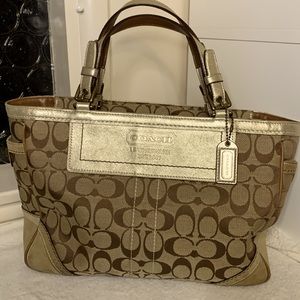 Signature Coach handbag with turn lock side pocket and large zipper closure